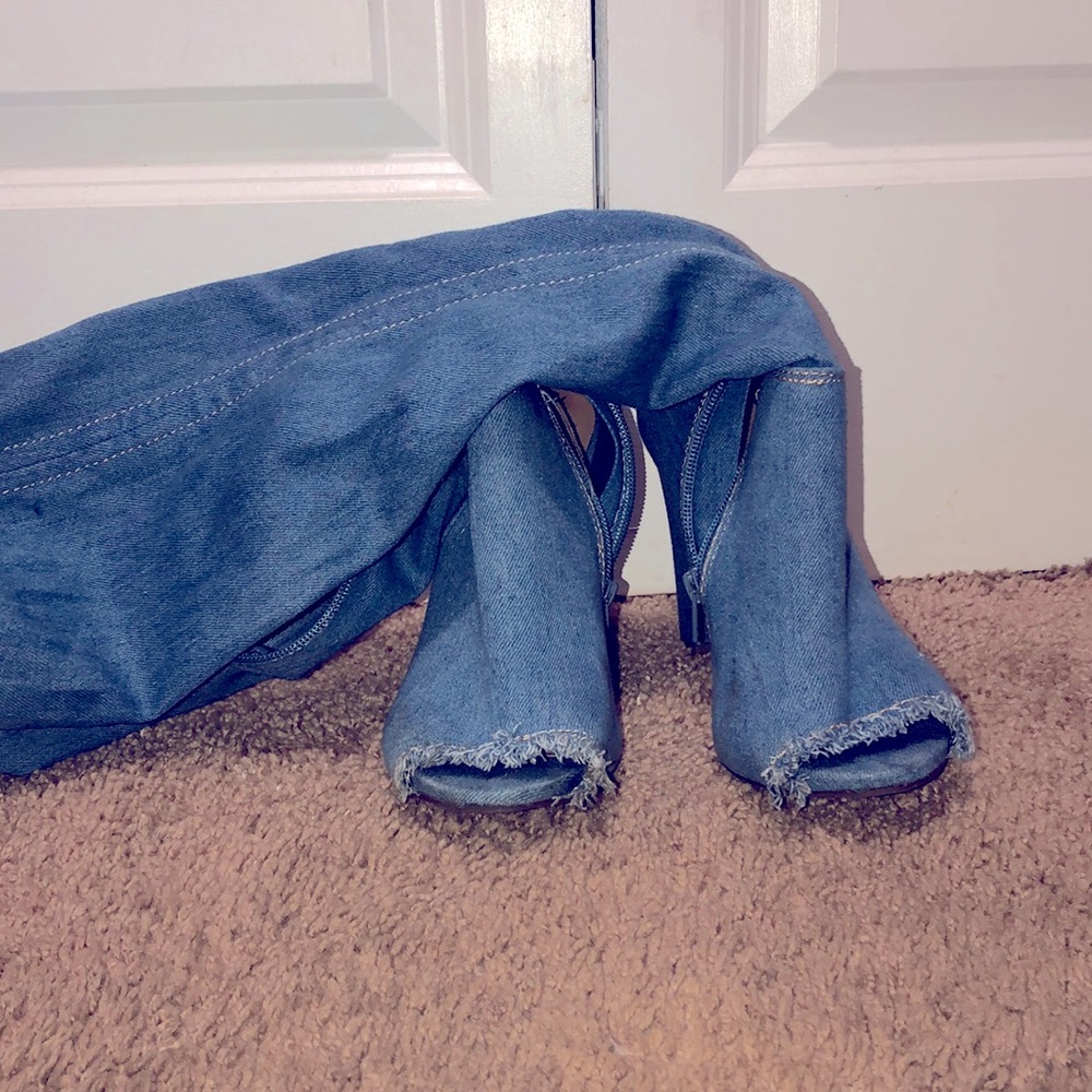 Knee high blue Jean boots with rips